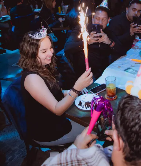 A birthday cake with candles at a party